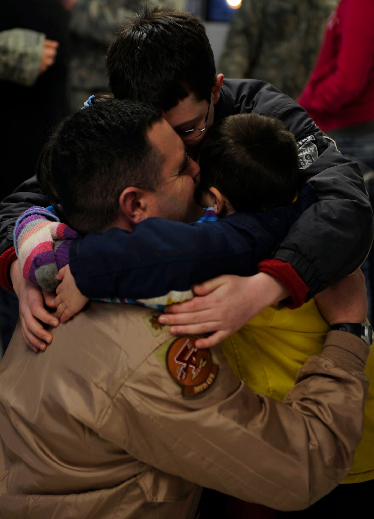 MOUNTAIN HOME AIR FORCE BASE, Idaho - -Major Duane Henry, 389th Fighter squadron, says his last goodbyes to his children before departing for a deployment in support of Operation Enduring Freedom March 7. More than 400 Airmen from across the 366th Fighter Wing are deploying to Southwest Asia where the 389th Fighter Squadron "T-Bolts" will conduct combat operations. (U.S. Air Force photo by Airman 1st Class Renishia Richardson)