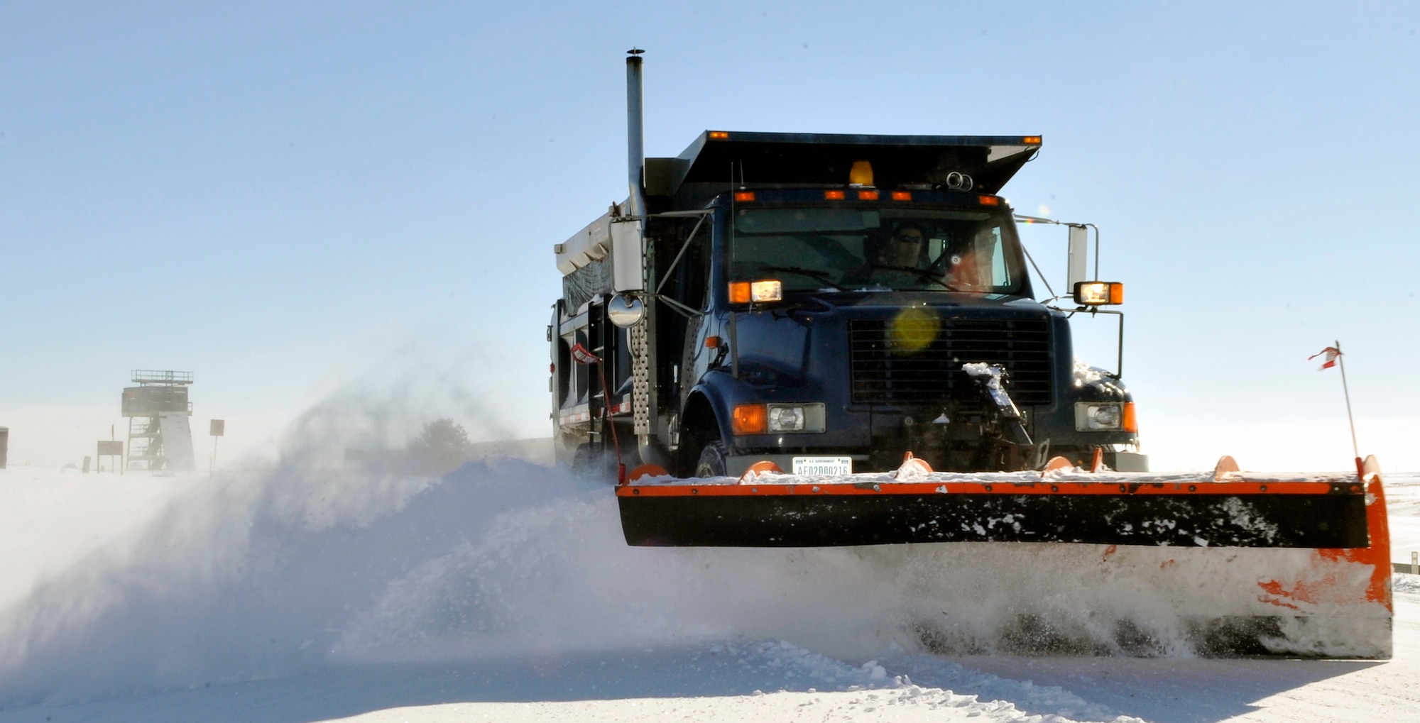 BUCKLEY AIR FORCE BASE, Colo. -- A plow truck plows snow from the road January 1, 2011. When winter weather hits Buckley AFB the 460th 460th Civil Engineering Squadron are one of the first  ones on base to make sure we arrive safely. (U.S. Air Force photo by Airman 1st Class Paul Labbe.)
