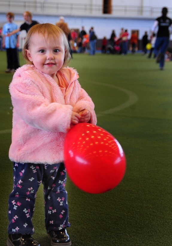 Christine Moore, daughter of David and Lora Moore, enjoys a day of activities during the base Family Fun N’ Games day in the PRIDE Hangar at Ellsworth Air Force Base, S.D., March 5, 2011  The Airman and Family Readiness Center provided balloons, an obstacle course, giant bowling and jumping castles for the children to enjoy. (U.S. Air Force photo/Senior Airman Anthony Sanchelli)
