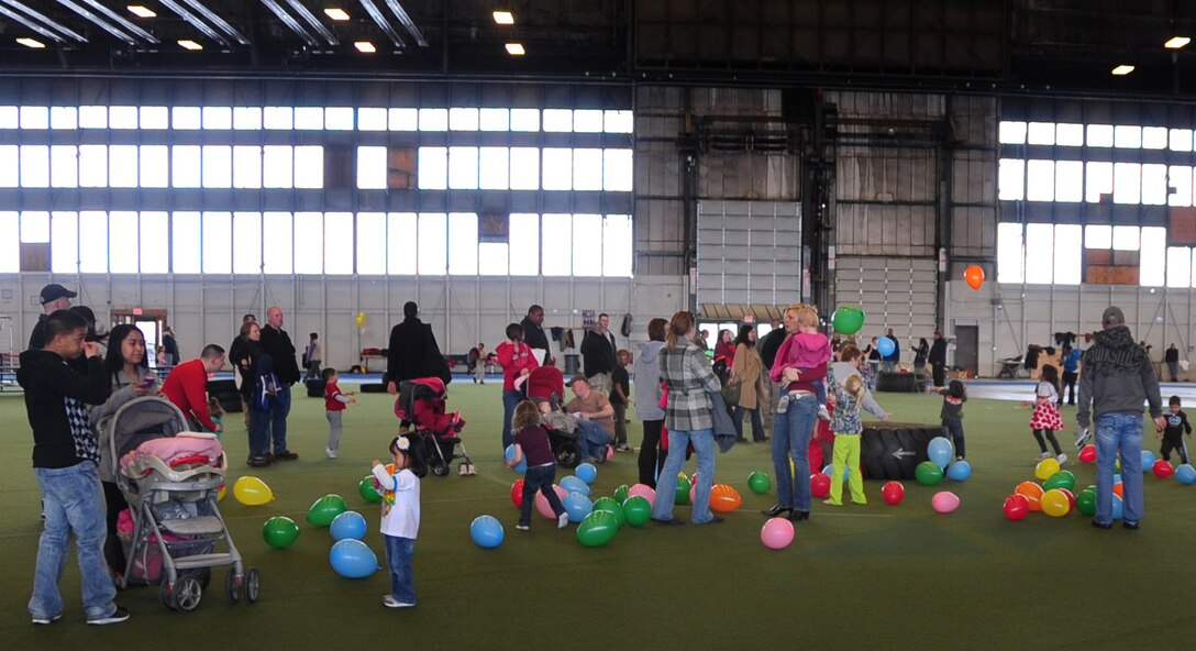 Airmen and their families enjoy an afternoon of activities during the base Family Fun N’ Games day in the PRIDE Hangar at Ellsworth Air Force Base, S.D., March 5, 2011.  The Airman and Family Readiness Center provided balloons, an obstacle course, giant bowling and jumping castles for the children to enjoy. (U.S. Air Force photo/Senior Airman Anthony Sanchelli)
