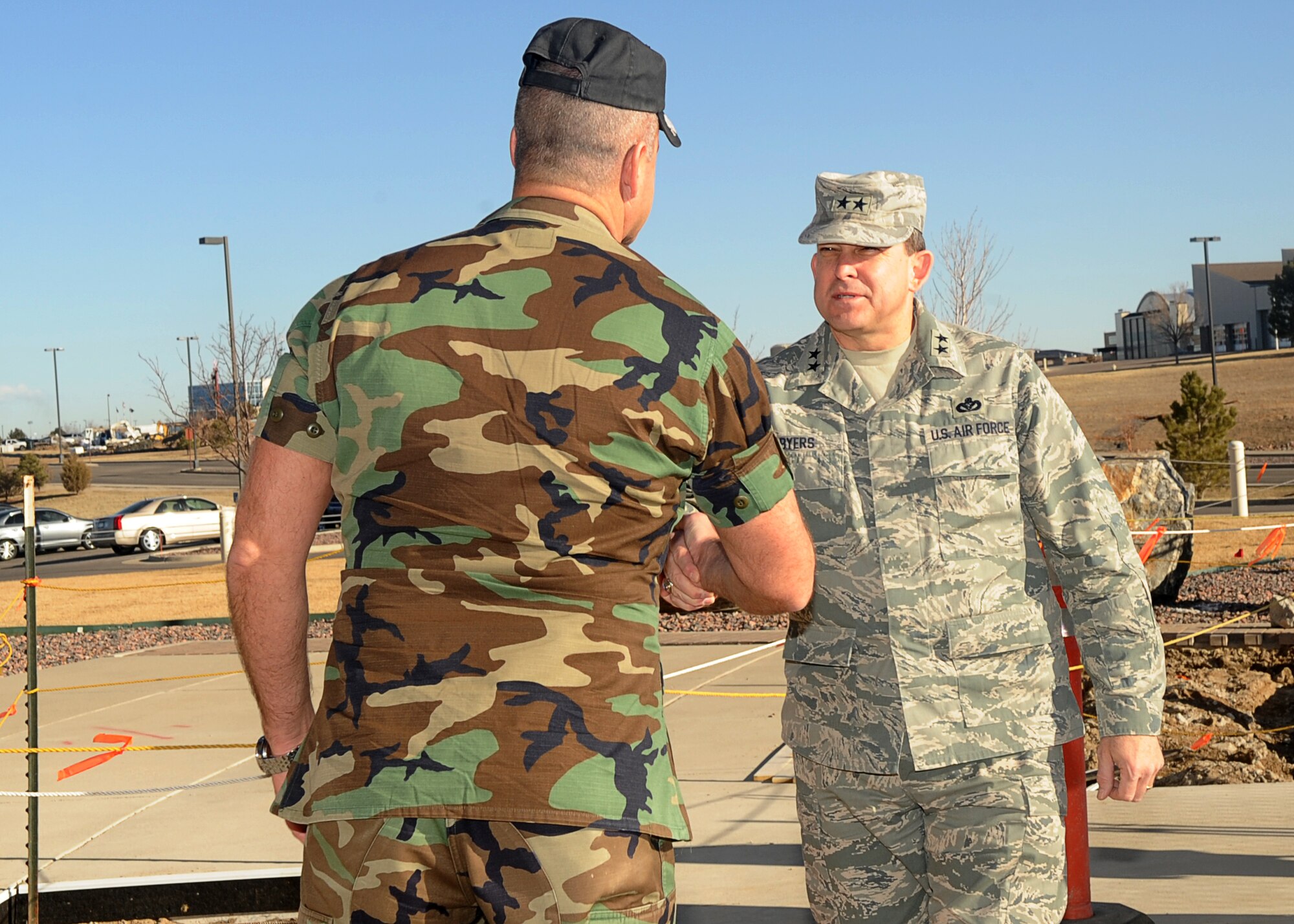 Buckley Air Force Base, Colo.- Maj. Gen. Timothy Byers, Air Force Civil Engineer, and Col. Trent Pickering 460th Space Wing Vice Commander shake hands outside of the Headquarters building Mar 3, 2011. Maj. Gen Byers visited Buckley to inspect the Visitors Quarters/Temporary Lodging Facility.  ( U.S. Air Force Photo by Airman 1st Class Marcy Glass )
