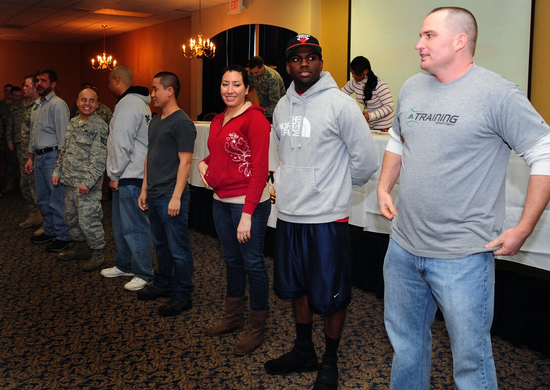 Airmen line up for the first "Man vs. Food" competition at Ellsworth Air Force Base S.D., March 4, 2011.  Sixteen Airmen from across the base participated in the competition to see who could eat a dozen “atomic” hot wings within three minutes. (U.S. Air Force photo/Senior Airman Anthony Sanchelli)