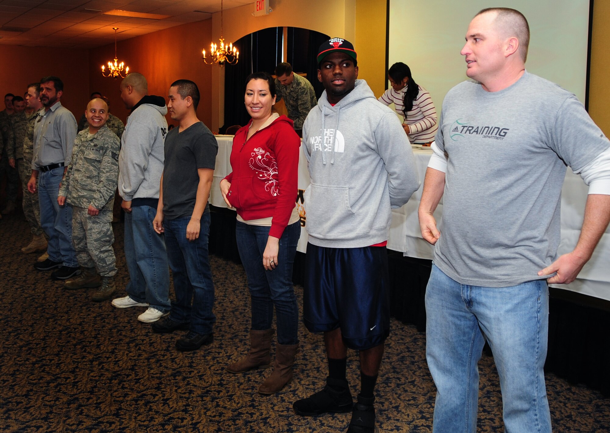 Airmen line up for the first "Man vs. Food" competition at Ellsworth Air Force Base S.D., March 4, 2011.  Sixteen Airmen from across the base participated in the competition to see who could eat a dozen “atomic” hot wings within three minutes. (U.S. Air Force photo/Senior Airman Anthony Sanchelli)