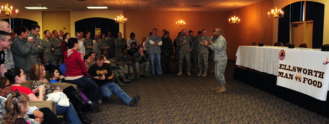 (Right) Col. Trent Edwards, 28th Mission Support Group commander, welcomes everyone to the first "Man vs. Food" competition at Ellsworth Air Force Base S.D., March 4, 2011.  Sixteen Airmen from across the base participated in the competition to see who could eat a dozen “atomic” hot wings within three minutes. (U.S. Air Force photo/Senior Airman Anthony Sanchelli)
