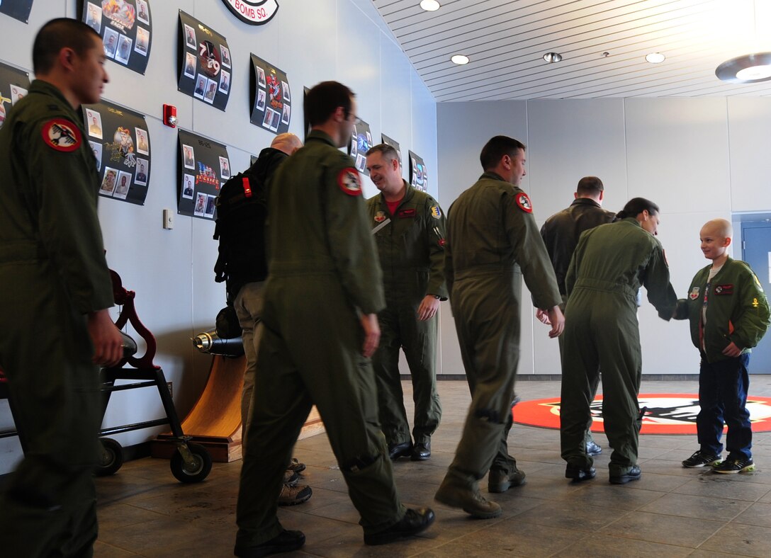 Eight-year-old Noah Misselt from Box Elder, S.D., shakes hands with all the aircrew members of the 34th Bomb Squadron as he becomes a honorary aircrew member, as part of the Aircrew for a Day program at Ellsworth Air Force Base, S.D., March 4, 2011.  Noah was diagnosed with leukemia in 2008 and began chemotherapy almost immediately. (U.S. Air Force photo/Senior Airman Anthony Sanchelli)  
