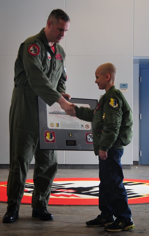 Eight-year-old Noah Misselt from Box Elder, S.D., becomes a honorary aircrew member of the 34th Bomb Squadron as part of the Aircrew for a Day program at Ellsworth Air Force Base, S.D., March 4, 2011.  Noah, who was diagnosed with leukemia in 2008, received a B-1B Lancer lithograph, signed by members of the 34th Bomb Squadron, from Lt. Col. Steven Beasley, 34th Bomb Squadron commander. (U.S. Air Force photo/Senior Airman Anthony Sanchelli)   
