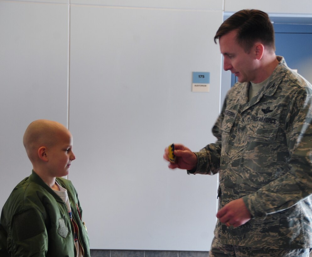 Eight-year-old Noah Misselt from Box Elder, S.D., becomes a honorary aircrew member of the 34th Bomb Squadron as part of the Aircrew for a Day program at Ellsworth Air Force Base, S.D., March 4, 2011.  Noah, who was diagnosed with leukemia in 2008, received a 28th Bomb Wing patch for his flight jacket from Col. Jeffrey Taliaferro, 28th BW commander, as part of his initiation into the squadron. (U.S. Air Force photo/Senior Airman Anthony Sanchelli)   
