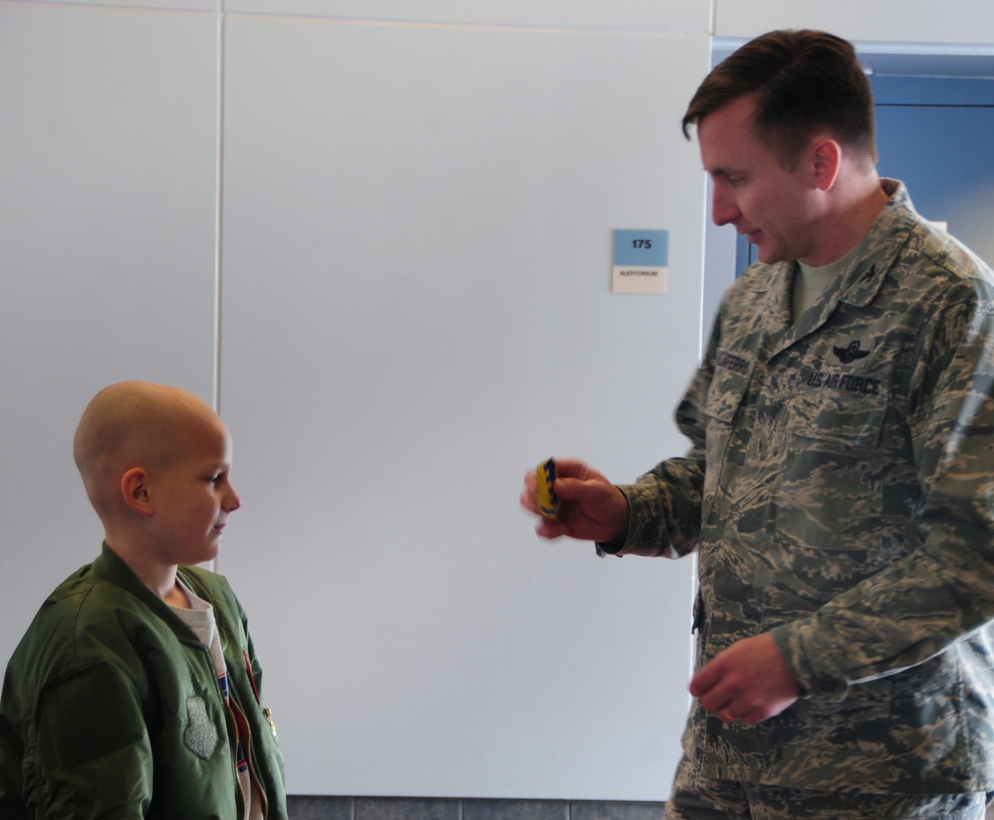 Eight-year-old Noah Misselt from Box Elder, S.D., becomes a honorary aircrew member of the 34th Bomb Squadron as part of the Aircrew for a Day program at Ellsworth Air Force Base, S.D., March 4, 2011.  Noah, who was diagnosed with leukemia in 2008, received a 28th Bomb Wing patch for his flight jacket from Col. Jeffrey Taliaferro, 28th BW commander, as part of his initiation into the squadron. (U.S. Air Force photo/Senior Airman Anthony Sanchelli)   
