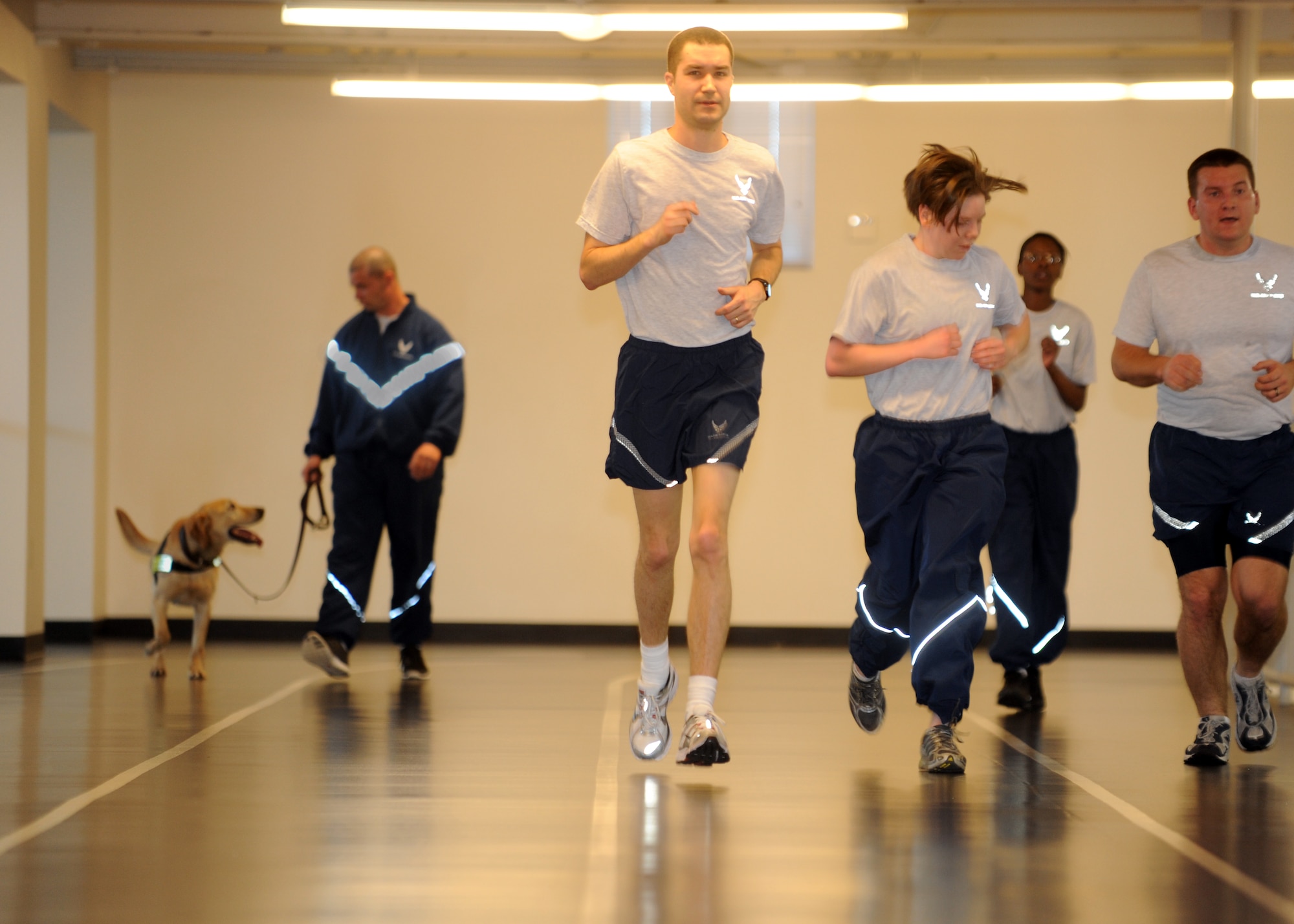 Buckley Air Force Base, Colo.- Satff Sergeant David Duritsky and Pier, 460th Security Forces squadron, share a satisfied glance towards one another during their cool down lap at the fitness center Mar 2, 2011. Buckley is one of few bases instituting this new program to keep the military working dogs physically fit and deployment ready.  ( U.S. Air Force Photo by Airman 1st Class Marcy Glass )

