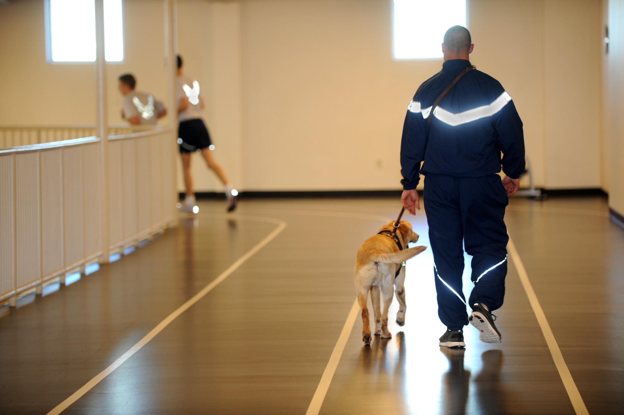Buckley Air Force Base, Colo.- Staff Sergeant David Duritsky and Pier, 460th Security Forces squadron, cool down after a morning of PT at the fitness center Mar 2, 2011. The new military working dog PT program allows security forces members and their K-9's time to train together. ( U.S. Air Force Photo by Airman 1st Class Marcy Glass )

