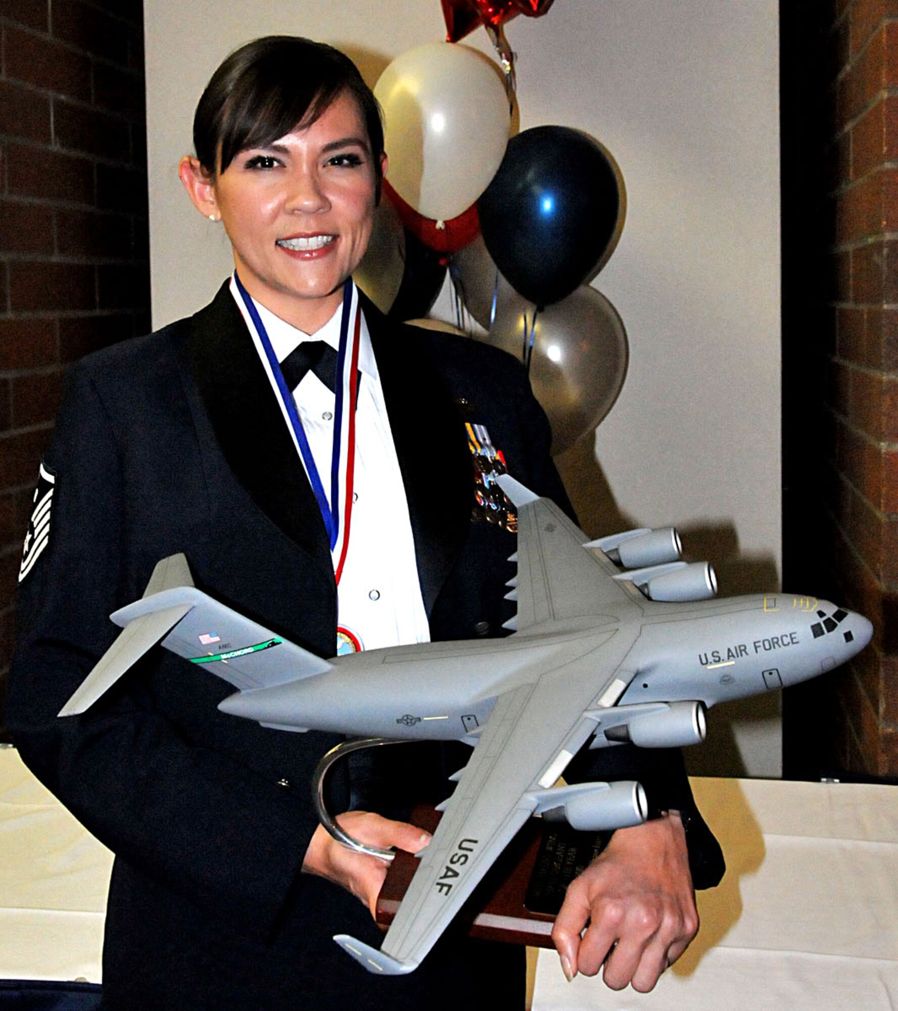 U.S. Air Force Master Sgt. Wendy Beauchaine, 446th Force Support Squadron first sergeant out of McChord Field, Wash., holds her First Sergeant of the Year trophy from the 2011 446th Airlift Wing Annual Awards banquet, Co-located Club, March 5, 2011. (U.S. Air Force photo by 2nd Lt. Denise Hauser/Released)