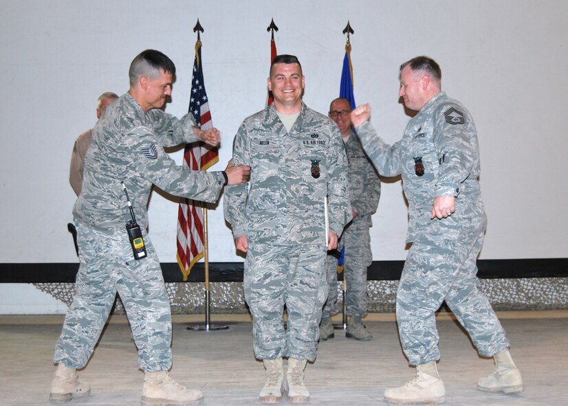 ALI AIR BASE, Iraq- Master Sgt. Sean Allen, deployed from Moody Air Force Base, Ga., has his new master sergeant stripes pinned on him by fellow firefighters Feb. 1. Sergeant Allen is currently on his seventh deployment. (Courtesy photo)(RELEASED)