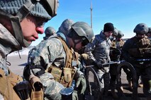 MINOT AIR FORCE BASE, N.D. – Members of the 791st Missile Security Forces Squadron Tactical Response Force watch as their fellow Airmen repel down Uniform-1, a training facility here, for TRF training here March 4. Everyone part of  the TRF must undergo a series of training designed to both push them beyond their physical limits and to evaluate how well they work under a great deal of pressure. (U.S. Air Force photo/ Senior Airman Jesse Lopez)