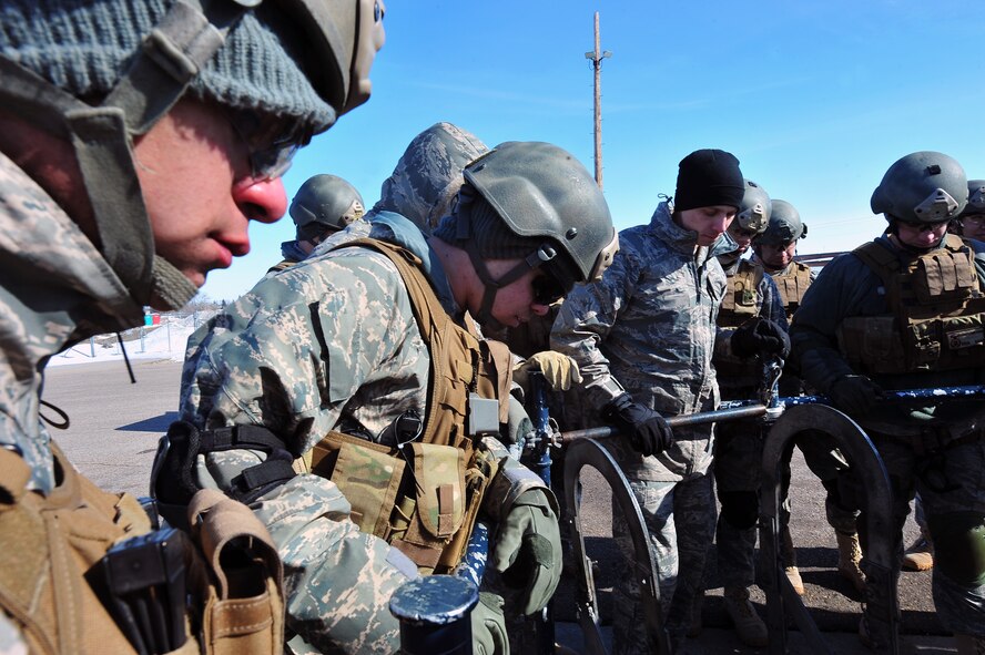 MINOT AIR FORCE BASE, N.D. – Members of the 791st Missile Security Forces Squadron Tactical Response Force watch as their fellow Airmen repel down Uniform-1, a training facility here, for TRF training here March 4. Everyone part of  the TRF must undergo a series of training designed to both push them beyond their physical limits and to evaluate how well they work under a great deal of pressure. (U.S. Air Force photo/ Senior Airman Jesse Lopez)