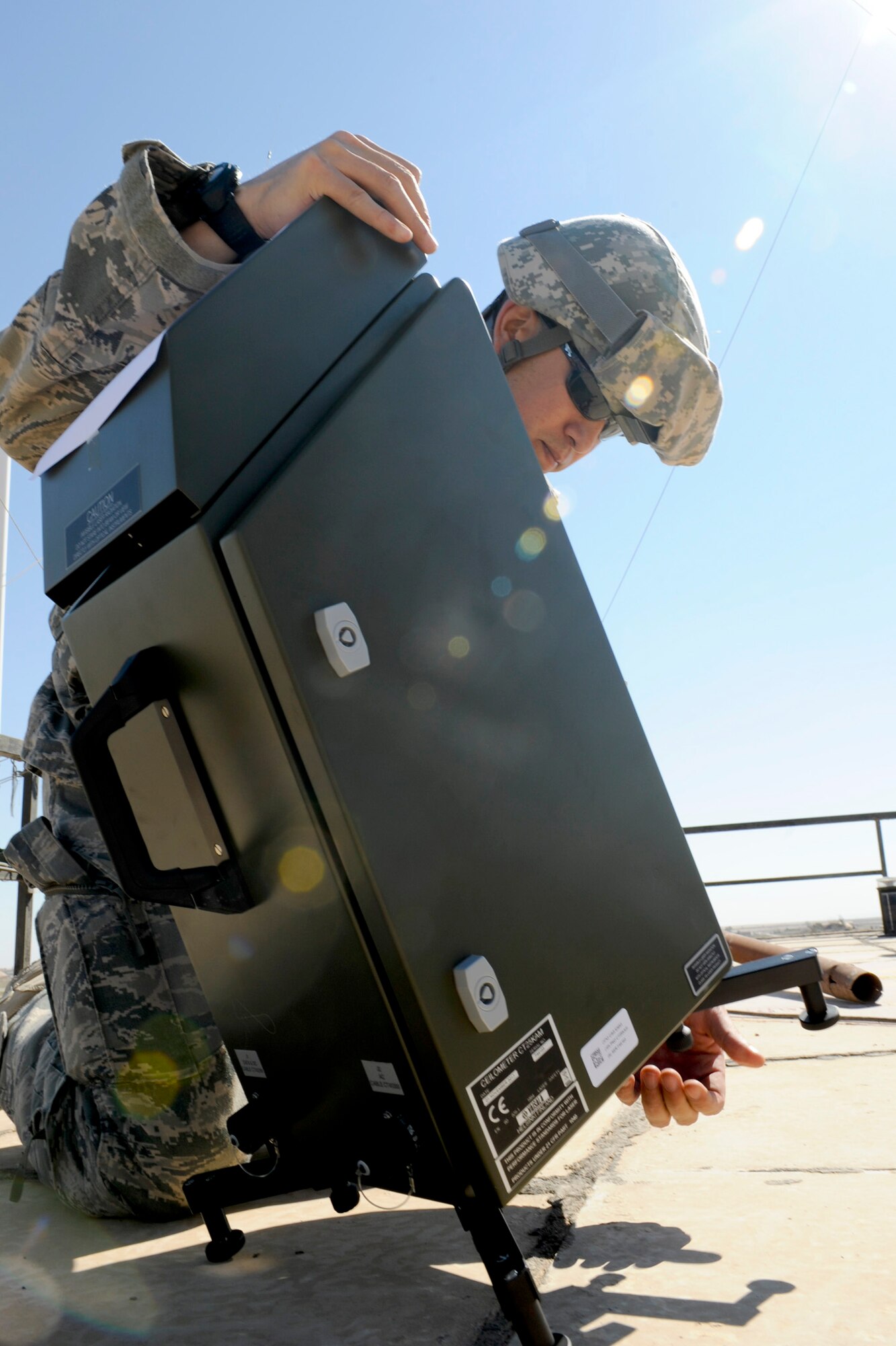 Master Sgt. Stephen Hale sets up part of a TMQ-53 weather observation system March 2, 2011, at Qayyarah West Airfield, Iraq. Sergeant Hale was part of a three-man weather team that traveled from Baghdad to retrieve U.S. Air Force equipment and install a newly purchased system as part of an ongoing process to set up a self-sustained Iraqi military weather service. Sergeant Hale is a 22nd Expeditionary Weather Squadron advising weather trainer. (U.S. Air Force photo/Staff Sgt. Levi Riendeau) 