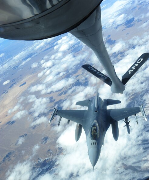 NELLIS AIR FORCE BASE, Nev. -- An F-16CJ Fighting Falcon departs from the refueling track of a KC-135R Stratotanker as part of Operation Red Flag 11-3 Feb. 28. The F-16 Fighting Falcon is a compact, multi-role fighter aircraft that is highly maneuverable and has proven itself in air-to-air combat and air-to-surface attack. The KC-135R has provided the core air refueling capability for the United States Air Force for over 50 years. Red Flag is a realistic combat training exercise that provides heavily-contested and degraded operational environments to prepare crews for major combat operations against a near-peer adversary. (U.S. Air Force photo by 2nd Lt. Tony Richardson) (Released)