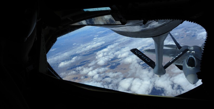 NELLIS AIR FORCE BASE, Nev. -- Technical Sgt. Jason Vinson, KC-135R boom operator from the 166th Air Refueling Squadron, guides an F-22A toward the refueling boom as part of a refueling mission during Red Flag 11-3 Feb. 28. The KC-135R has provided the core air refueling capability for the United States Air Force for over 50 years. The F-22A is designed to project air dominance and defeat threats attempting to deny access to our nation's Air Force, Army, Navy and Marine Corps. Red Flag is a realistic combat training exercise that provides heavily-contested and degraded operational environments to prepare crews for major combat operations against a near-peer adversary. (U.S. Air Force photo by 2nd Lt. Tony Richardson) (Released)