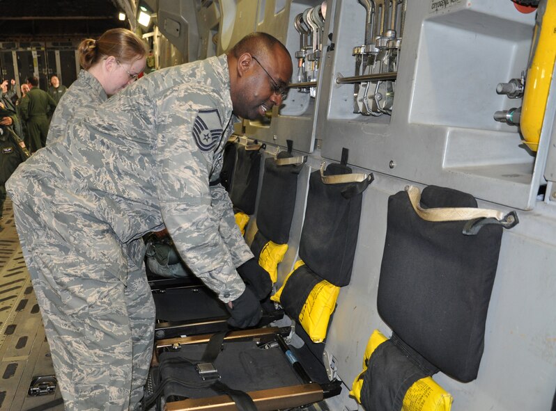 WRIGHT-PATTERSON AIR FORCE BASE, Ohio –Master Sgt. Maurice Upshaw and Staff Sgt. Kortnee Widup, both from the 445th Operations Support Squadron, inspect aircrew flight equipment on board a C-17 Globemaster III in preparation for a training flight Feb. 18. The flight marks the first time the 445th Aeromedical Evacuation Squadron participated in a training mission with other 445th units (the 89th Airlift Wing and 445th OSS).  (U.S. Air Force photo/Stacy Vaughn)