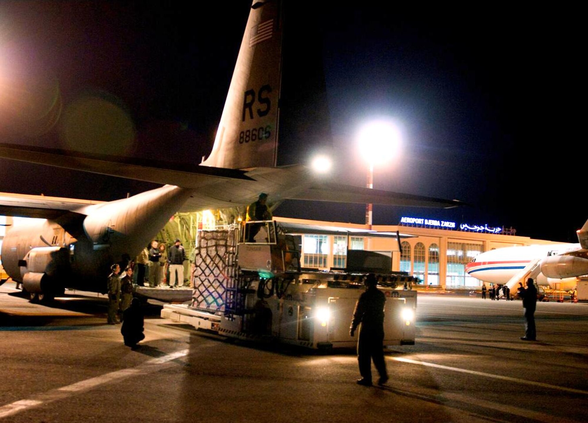 U.S. Airmen from the 435th Air Mobility Squadron out of Ramstein Air Base, Germany, unload blankets, tarps and water containers donated by the U.S. Agency for International Development off of a C-130 Hercules aircraft in Djerba, Tunisia, on March 4, 2011. The U.S. government is working intensely with the international community to meet the humanitarian needs of the Libyan people and others in the country who fled across the borders. (U.S. Air Force Photo/Staff Sgt. Brendan Stephens) 