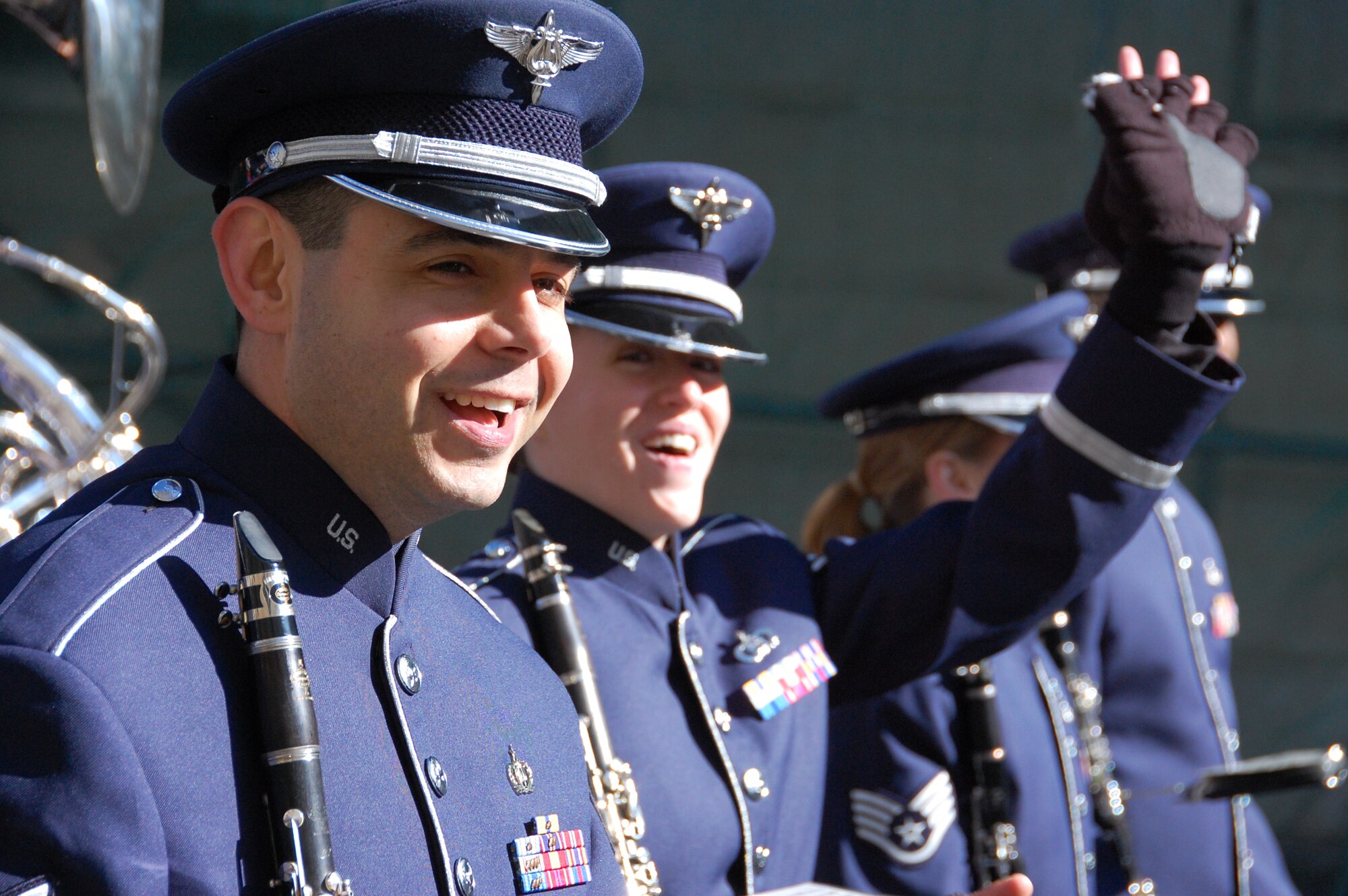 KOBLENZ, Germany -- U.S. Air Forces in Europe Band members Tech. Sgt. Igor Poklad and Staff Sgt. Chantelle Friedman wave to the spectators at the Rosenmontag Parade in Koblenz, Germany, March 7, 2011. (U.S. Air Force photo by Staff Sgt. Rachel Trimble)