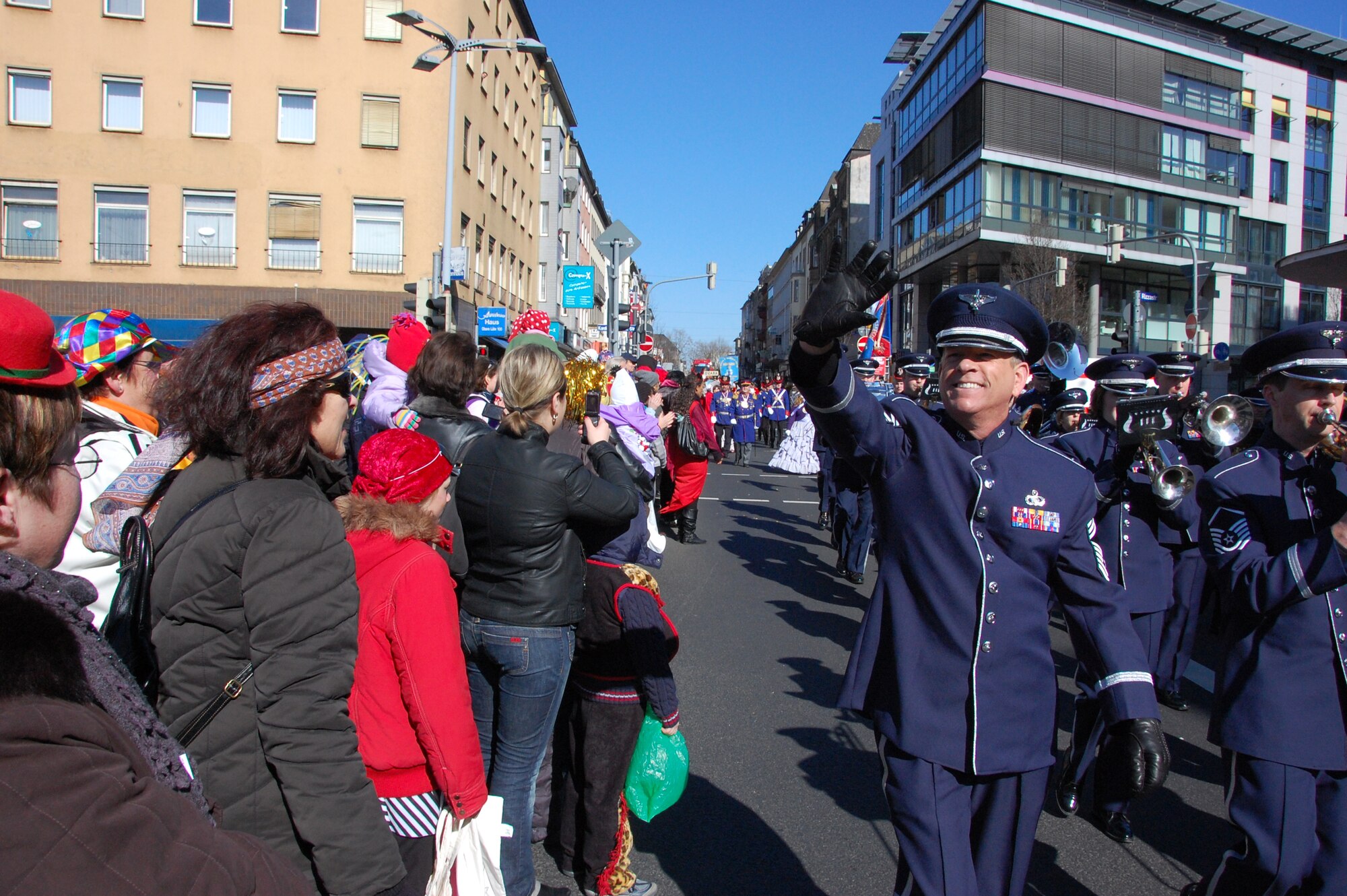 KOBLENZ, Germany -- Chief Master Sgt. William Castleman, manager of the U.S. Air Forces in Europe Band, waves to well wishers while the USAFE Band performs at the Rosemontag Parade in Koblenz, Germany, March 7, 2011. (U.S. Air Force photo by Staff Sgt. Rachel Trimble)