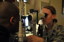 MINOT AIR FORCE BASE, N.D. -- Capt. Caitlyn Woods, 5th Medical Group optometry services chief, examines a patient as part of a refractive surgery follow up at the base clinic here Jan. 26. The optometry clinic prides itself in helping Airmen to see clearer and maintain their ocular health, which is essential to mission accomplishment at all levels of the Air Force. (U.S. Air Force photo/ Airman 1st Class Jessica McConnell)