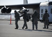 MINOT AIR FORCE BASE, N.D. -- Airmen of 5th Security Forces Squadron, escort two detained members of 5th Aircraft Maintenance Squadron during a suspected security incident here Mar. 1. The Airmen were on duty as part of an operational readiness inspection.  (U.S. Air Force photo/ Senior Airman Michael J. Veloz)