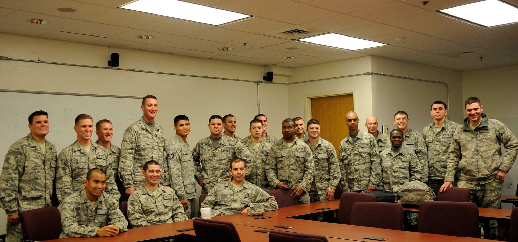 Airmen from the 633d Civil Engineer Squadron pose for a group photo following their re-deployment to Langley Air Force Base, Va., March 6, 2011. More than 20 engineers were greeted by friends and families after returning froma  six-month deployment to Afghanistan.  (U.S. Air Force photo by Staff Sgt. Dana Hill/Released)