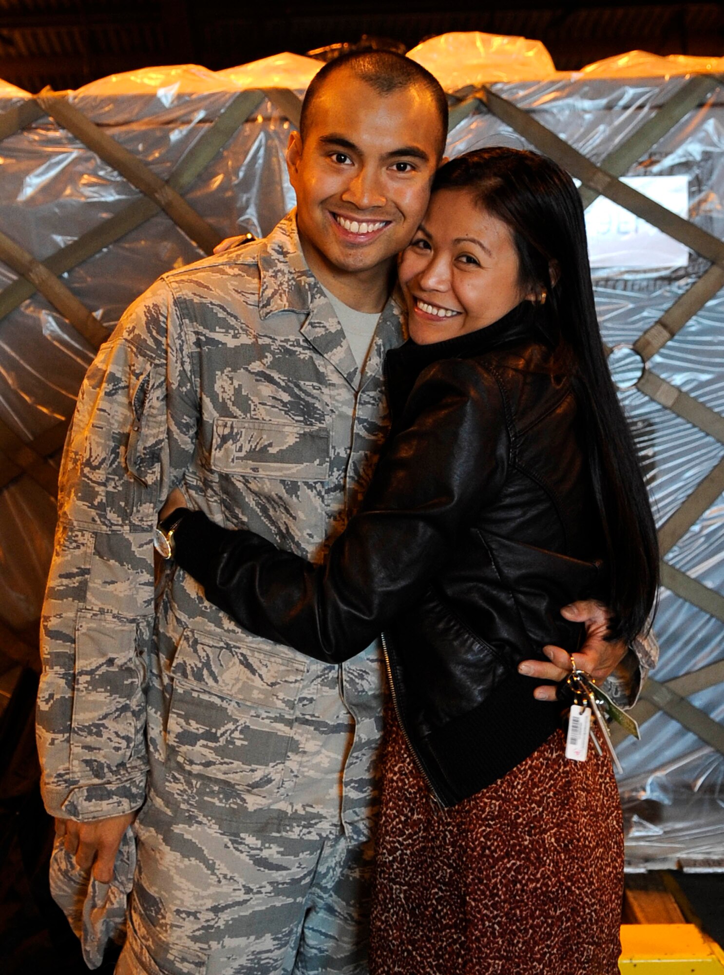 Staff Sgt. Raymond Hinal, 633d Civil Engineer Squadron electrical technician, hugs his wife Arlene at Langley Air Force Base, Va., March 6, 2011 after returning from a six-month deployment to Afghanistan. More than 20 engineers were greeted by friends and families during their homecoming celebration. (U.S. Air Force photo by Staff Sgt. Dana Hill/Released)