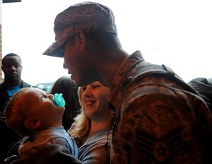 Staff Sgt. John Kominck, 633d Civil Engineer Squadron water and fuels system maintenance craftsmen, reunites with his wife Leanne and son Josiah at Langley Air Force Base, Va., March 6, 2011. More than 20 engineers returned home from a six-month tour in Afghanistan.  (U.S. Air Force photo by Staff Sgt. Dana Hill/Released)