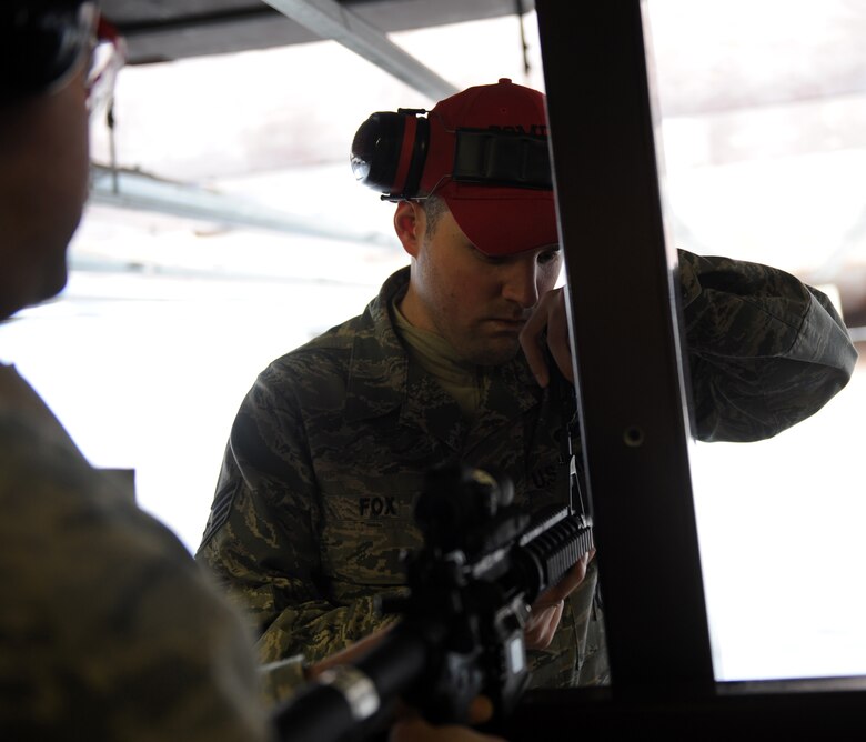 Staff Sgt. Derek Fox, 375th Security Force Squadron CATM instructor, adjusts the front sight of an M-4 Mar. 3, 2011 at Scott Air Force Base, Ill.  Scott's CATM instructors train more than 1,500 Airmen a quarter. (U.S Air Force photo/ Airman 1st Class Divine Cox)