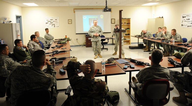 Staff Sgt. Richard Barber and Staff Sgt. Derek Fox, 375th Security Force Squadron combat arms training maintenance instructors, teach a class on CATM Mar. 3, 2011 at Scott Air Force Base, Ill.  Scott's CATM instructors train more than 1,500 Airmen a quarter. (U.S Air Force photo/ Airman 1st Class Divine Cox)