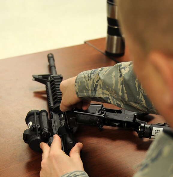 Tech. Sgt. Michael Bushee, 635th Supply Chain Operations Group stock control technician, disassembles a weapon March 3, 2011 at Scott Air Force Base, Ill. Scott AFB's combat arms training and maintenance instructors with the 375th Security Forces Squadron train more the 1,500 Airmen a quarter in weapons training. (U.S Air Force Photo/Airman 1st Class Divine Cox) 