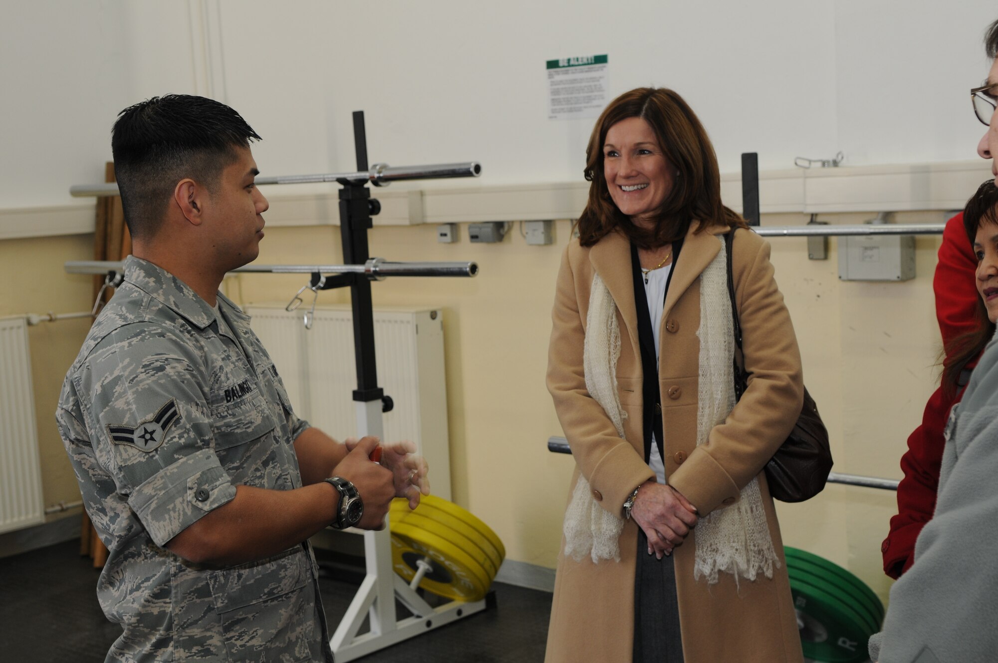 SPANGDAHLEM AIR BASE, Germany –Airman 1st Class Frank Balingit, 52nd Force Support Squadron combat fitness facility manager, talks with Betty Welsh, wife of U.S. Air Forces in Europe Commander Gen. Mark A. Welsh III, about the combat fitness program here March 3. General Welsh assumed command of USAFE in December 2010, and visited Spangdahlem AB with Chief Williamson and their wives to get a better understanding of the 52nd Fighter Wing’s mission and Airmen. (U.S. Air Force photo/Airman 1st Class Matthew B. Fredericks)