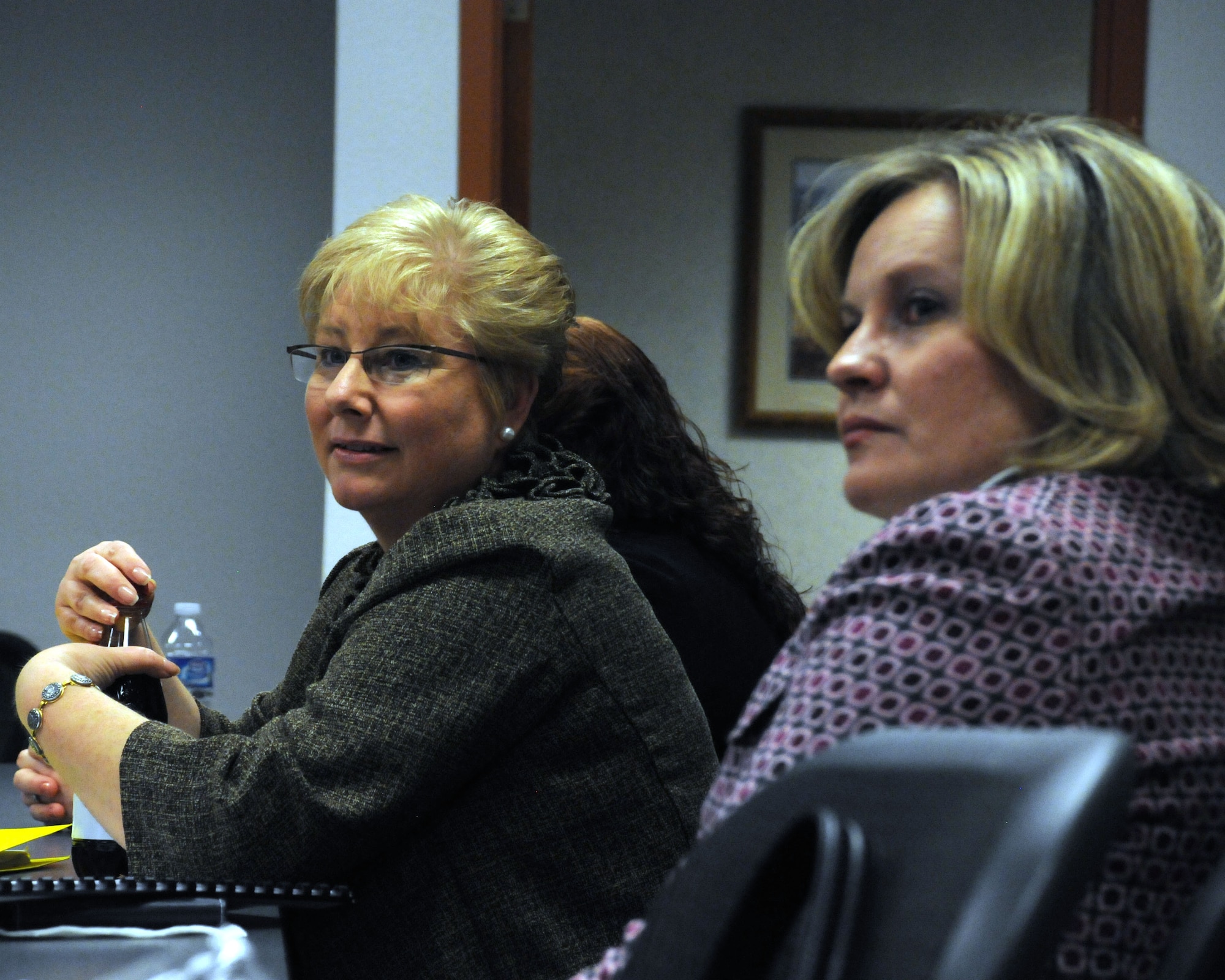 Paula Roy, wife of the Chief Master Sgt. of the Air Force James Roy, and Julie Tims, wife of Col. Gregory Tims, 90th Missile Wing commander, listen to a briefing at the Airman and Family Readiness Center at F.E. Warren AFB, Wyo., March 3. (U.S. Air Force photo by R.J. Oriez)
