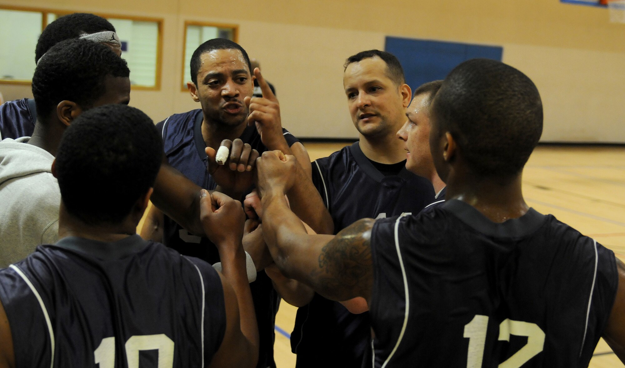 RAF MILDENHALL, England -- Corey Fletcher, 100th Maintenance Group basketball coach, gives his team a pep-talk at half time during the RAF Mildenhall 2011 Intramural Basketball Championship Feb. 4 at the Hardstand Fitness Center.  The game ended with a final score of 70-53, 100th LRS over 100th MXG. (U.S. Air Force photo/Senior Airman Tabitha M. Lee)