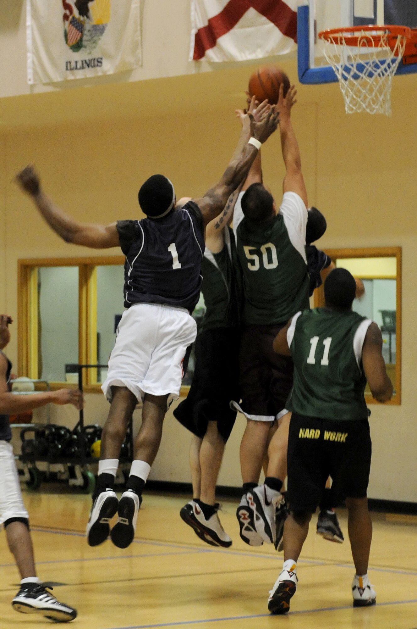 RAF MILDENHALL, England -- Players from the 100th's Logistics Readiness Squadron and Maintenance Group jump for a rebound during the RAF Mildenhall 2011 Intramural Basketball Championship Feb. 4 at the Hardstand Fitness Center.  The game ended with a final score of 70-53, 100th LRS over 100th MXG. (U.S. Air Force photo/Senior Airman Tabitha M. Lee) 