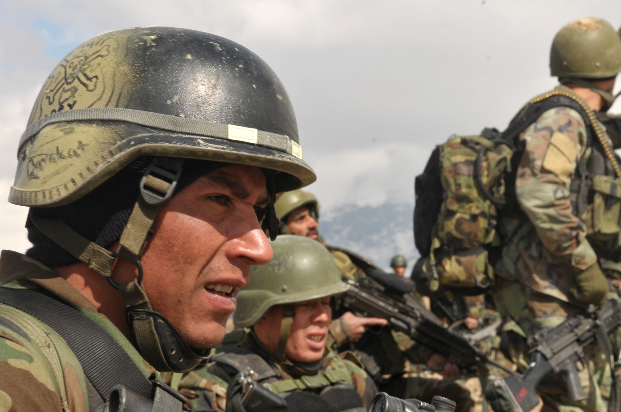 Afghan National Army Special Forces commandos look out for enemy combatants during a joint training exercise between the AAF and SF commandos held outside of Kabul March 5. The exercise was the first joint training mission between AAF and SF commandos to see AAF forward observers working with ANA ground forces to provide a link between air and ground initiatives. A precedent that AAF Brig. Gen. Mohammed Barat, the Kabul Wing commander, sees as a major step towards better cooperation and cohesion between the two forces. (U.S. Navy photo by Mass Communications Specialist 2nd Class Vladimir Potapenko).