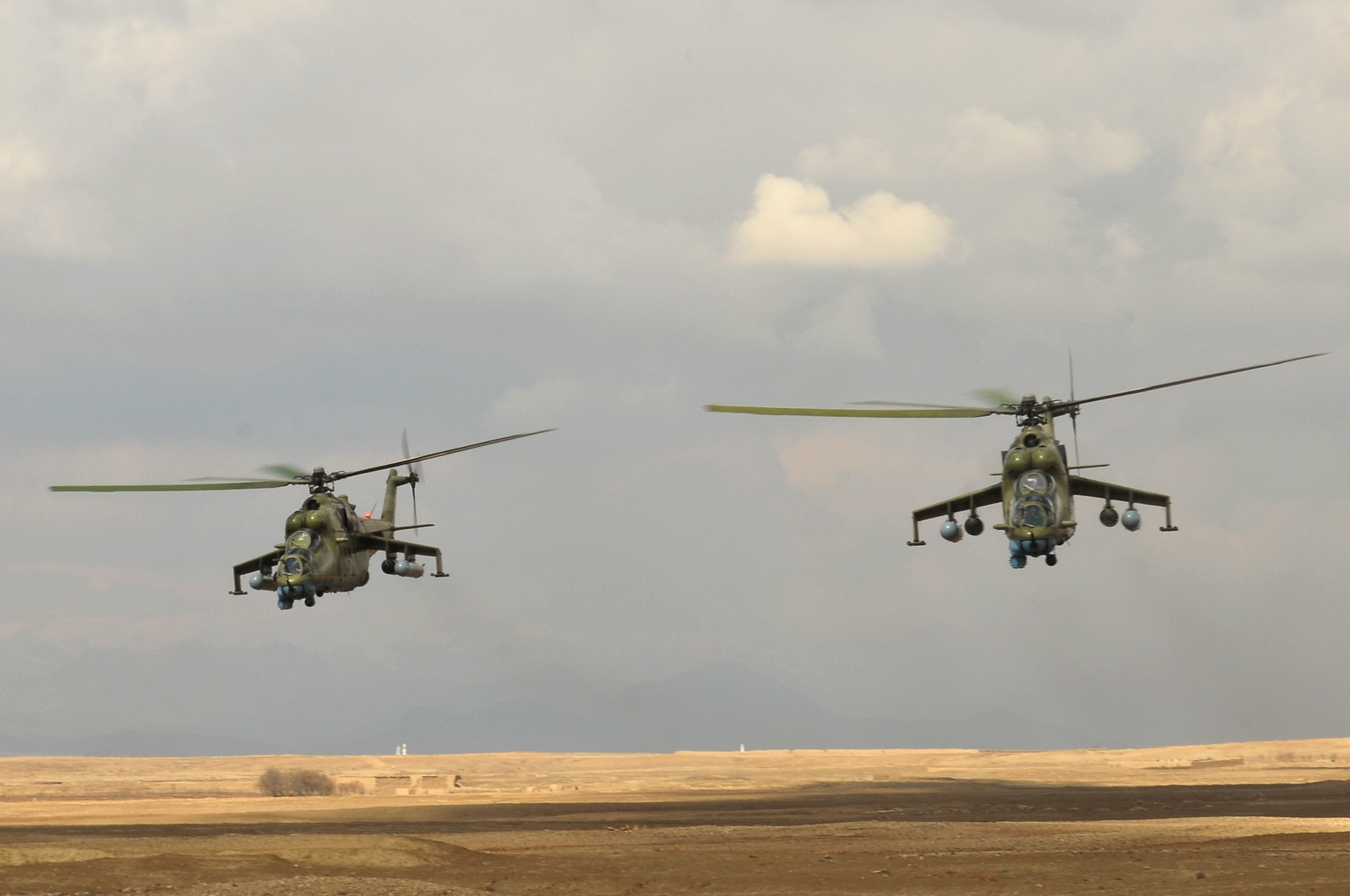 Afghan Air Force Mi-35 helicopters provide close air support for Afghan National Army Special Forces commandos engaging enemy combatants during a joint training exercise between the AAF and SF commandos held outside of Kabul March 5. The exercise was the first joint training mission between AAF and SF commandos to see AAF forward observers working with ANA ground forces to provide a link between air and ground initiatives. A precedent that AAF Brig. Gen. Mohammed Barat, the Kabul Wing commander, sees as a major step towards better cooperation and cohesion between the two forces. (U.S. Navy photo by Mass Communications Specialist 2nd Class Vladimir Potapenko).