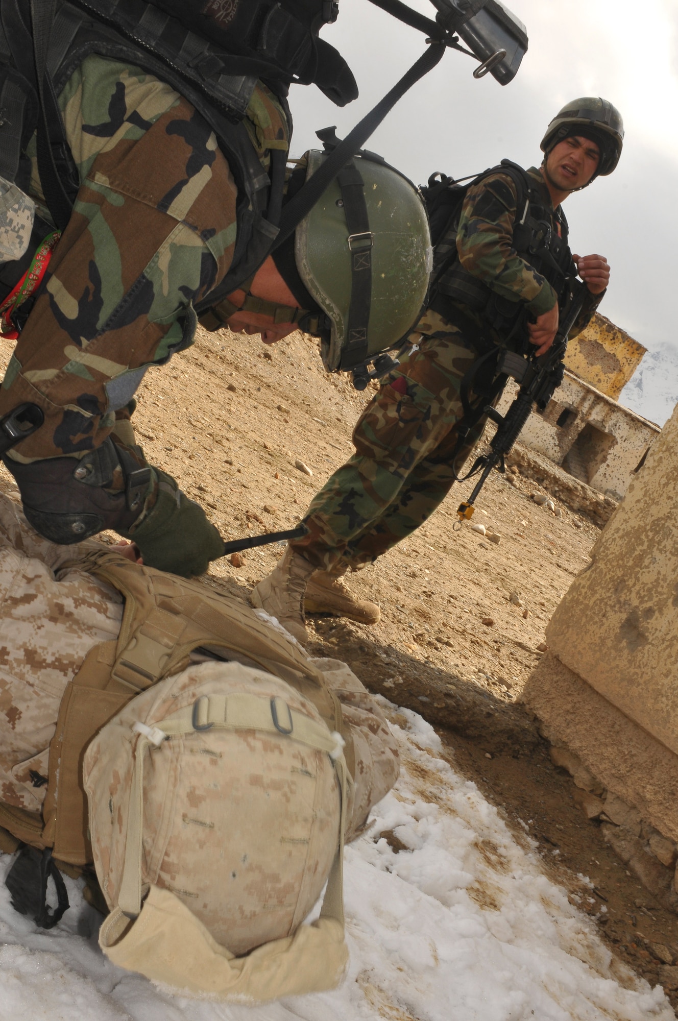 Afghan National Army Special Forces commandos apprehend an enemy combatant during a simulated raid on an opposing compound as part of joint training exercise between Afghan Air Force and SF commandos held outside of Kabul March 5. The exercise was the first joint training mission between AAF and SF commandos to see AAF forward observers working with ANA ground forces. A precedent that AAF Brig. Gen. Mohammed Barat, the Kabul Wing commander, sees as a major step towards better cooperation and cohesion between the two forces. (U.S. Navy photo by Mass Communications Specialist 2nd Class Vladimir Potapenko) .