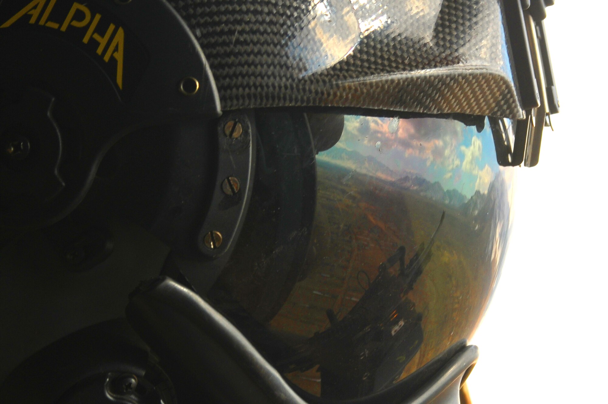 A Czech flight engineer advisor with NATO Air Training Command-Afghanistan provides fire support watch as an Afghan Air Force Mi-17 helicopter makes it way to a joint training mission between AAF and Afghan National Army Special Forces commandos outside of Kabul March 5. The exercise was the first joint training mission between AAF and SF commandos to see AAF forward observers working with ANA ground forces. A precedent that AAF Brig. Gen. Mohammed Barat, the Kabul Wing commander, sees as a major step towards better cooperation and cohesion between the two forces. (U.S. Navy photo by Mass Communications Specialist 2nd Class Vladimir Potapenko) 
