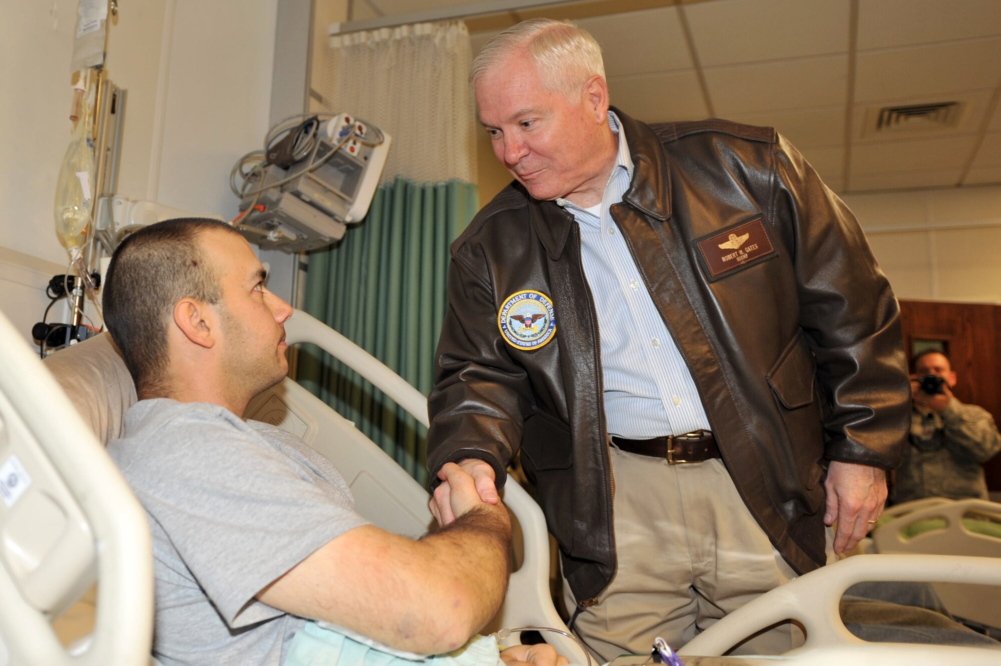 Defense Secretary Robert M. Gates shakes hands with Spc. Gregory Miller during his Purple Heart ceremony at Craig Joint Theater Hospital at Bagram Airfield, Afghanistan, March 7, 2011. (U.S. Air Force photo by Senior Airman Sheila deVera)