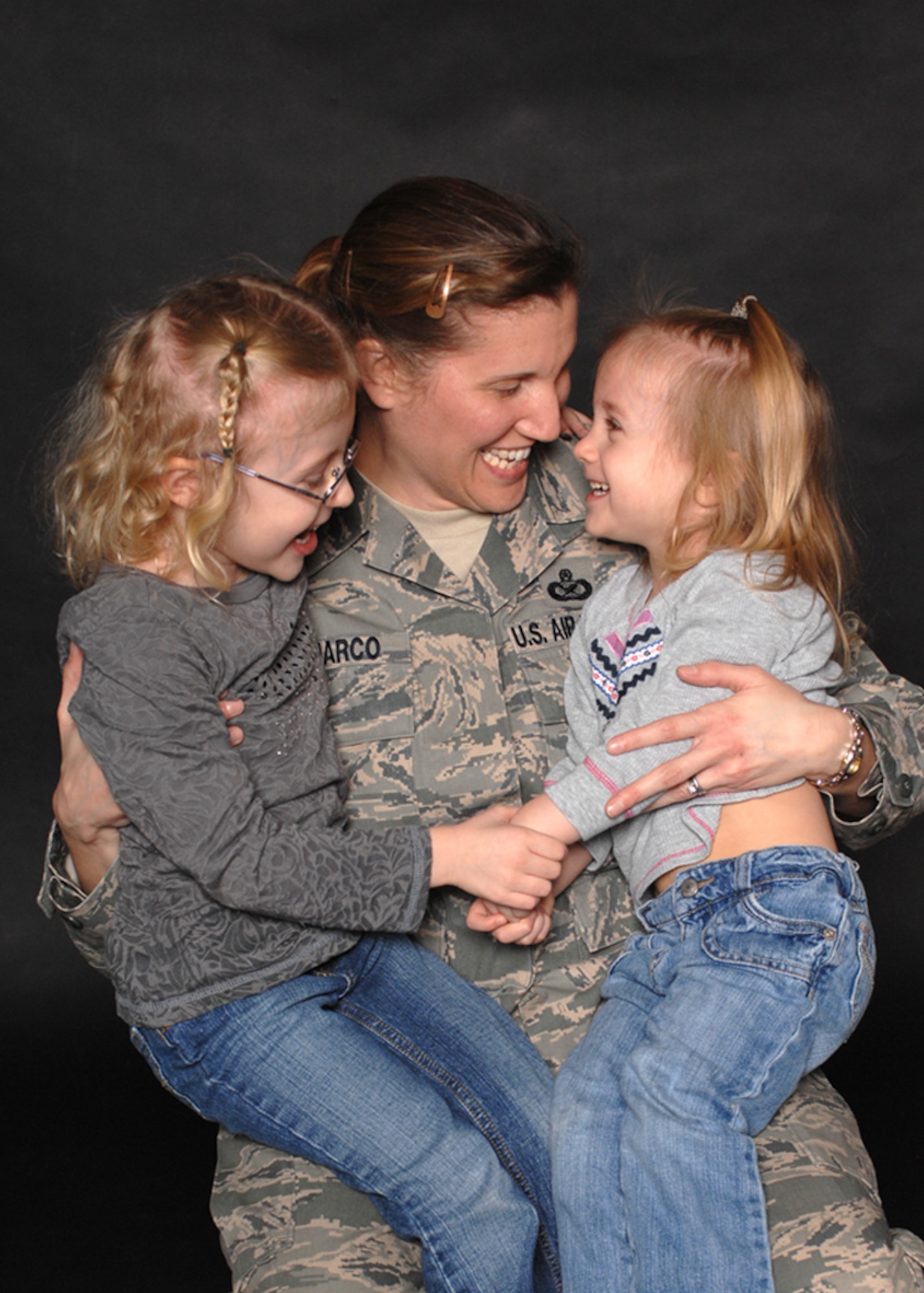 Master Sgt. Tracy DeMarco, with daughters Rachel (left), and Chloe. Sergeant DeMarco shares her thoughts and personal experiences on being a deployed mother in her commentary, "Deployed moms, every MAJCOM has them" (U.S. Air Force photo/Staff Sgt. Jerry Fleshman)