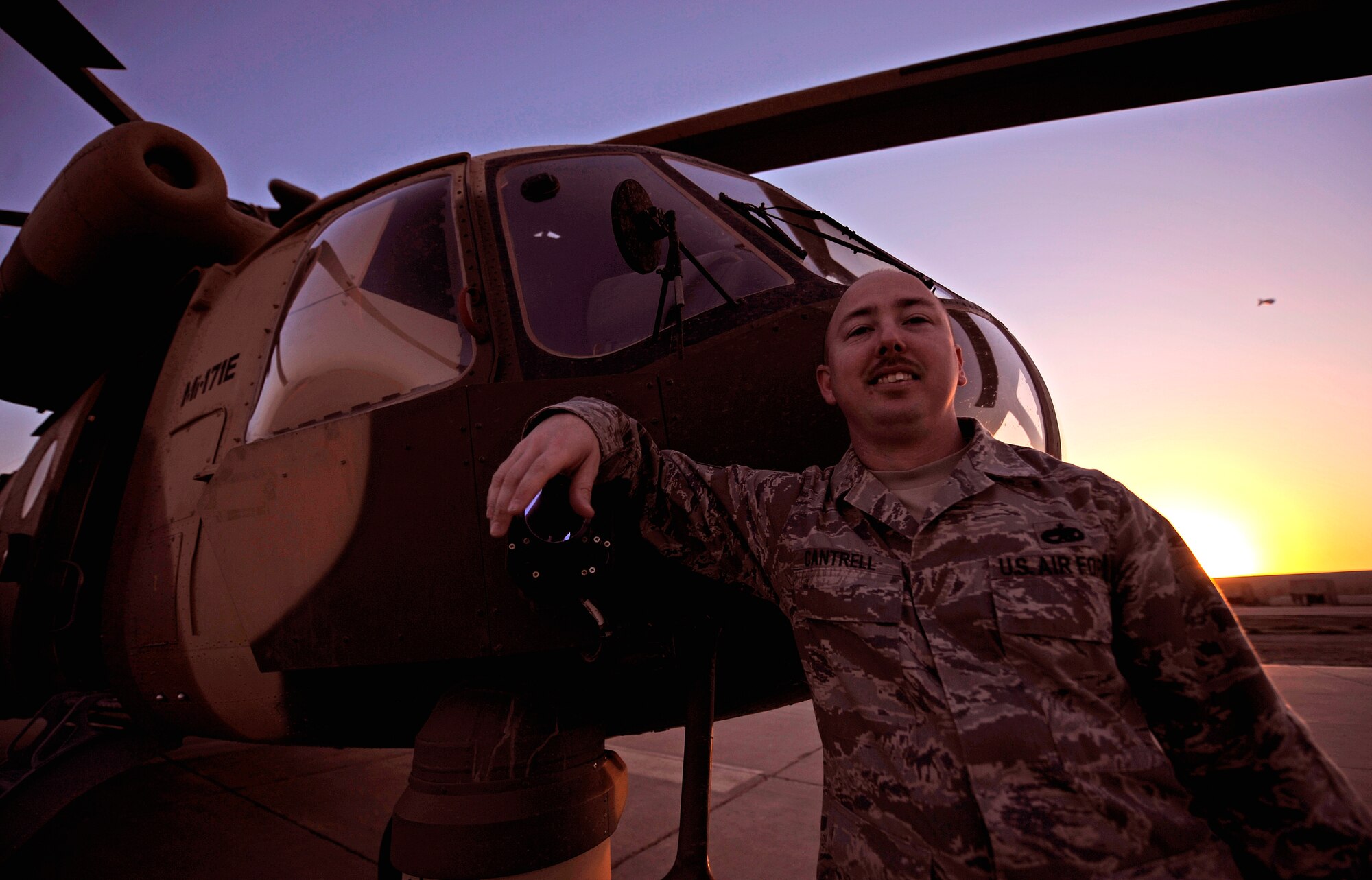 CAMP TAJI, Iraq -- U.S. Air Force Tech. Sgt. Kevin Cantrell, 721st Air Expeditionary Advisory Squadron ammo and logistics advisor to the Iraqi Army Aviation Command, poses in front of an Iraqi Mi-171 multi-mission helicopter where he trains his counterparts to safely load munitions. Sergeant Cantrell was recently recognized as Air Combat Command's 2010 Logistics Safety Outstanding Achievement award winner for his efforts with the F-22 Raptor at homestation and his contributions to the Iraqi Army Aviation Command. He was coined by the former Iraq Training and Advisory Mission - Air director last fall and has been named NCO of the Month three times during his year-long deployment. Sergeant Cantrell is deployed from Langley Air Force Base, Va., and hails from Mobile, Ala. (USAF photo by Tech. Sgt. Jason Lake)