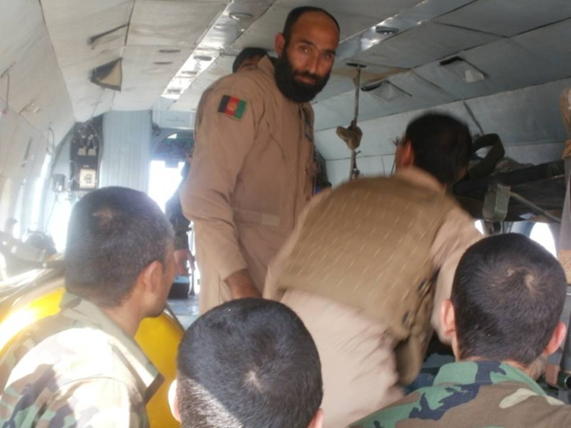 KANDAHAR, Afghanistan – Afghan Air Force flight medics Sor Gulab and Raheem instruct members of the Afghan National Army and AAF on patient loading of the Mi-17 transport helicopter March 5.  (U.S. Air Force courtesy photo).
