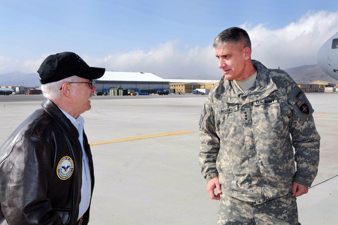U.S. Defense Secretary Robert M. Gates and U.S. Army Lt. Gen. David M. Rodriguez, commander of International Security Assistance Force Joint Command Afghanistan, chat on the flightline in Kabul, Afghanistan, March 7, 2011.