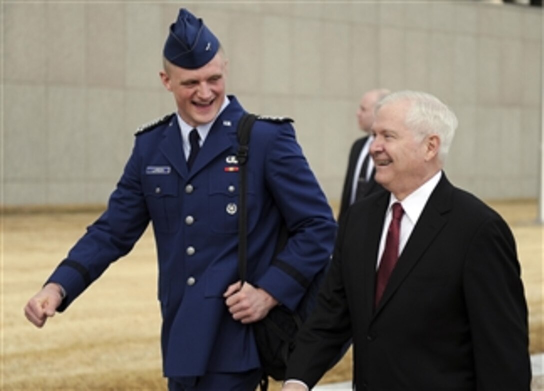 Secretary of Defense Robert M. Gates walks with U.S. Air Force Academy Cadet Wing Commander Josh Larson prior to teaching both a Political Science and National Security class as part of the Capstone Seminar at the Air Force Academy in Colorado Springs, Co., on March 4, 2011.  