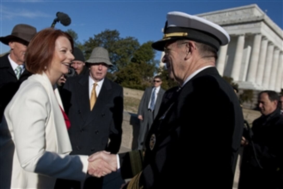Chairman of the Joint Chiefs of Staff Adm. Mike Mullen, U.S. Navy, greets Australian Prime Minister Julia Gillard at a ceremony on the steps of the Lincoln Memorial in Washington, D.C., on March 7, 2011.  The ceremony announced the donation of $3.3 million by the Australian government to help fund the "Education Center at the Wall" that would be located near the Vietnam Veterans' Memorial.  