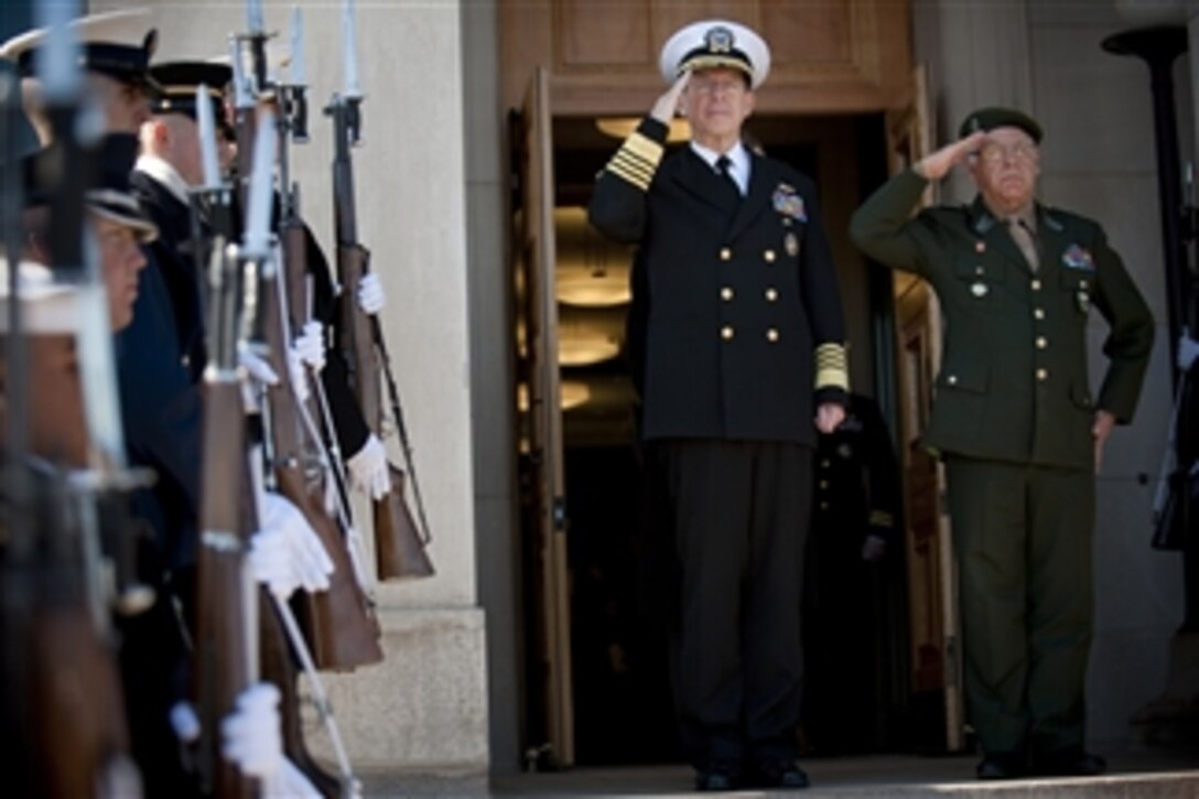Chairman of the Joint Chiefs of Staff Adm. Mike Mullen, U.S. Navy, and Brazilian Armed Forces Joint Staff Chief Gen. Jose Carlos DiNardi salute during the playing of their national anthems at a welcoming ceremony for DiNardi at the Pentagon in Washington, D.C., on March 7, 2011.  