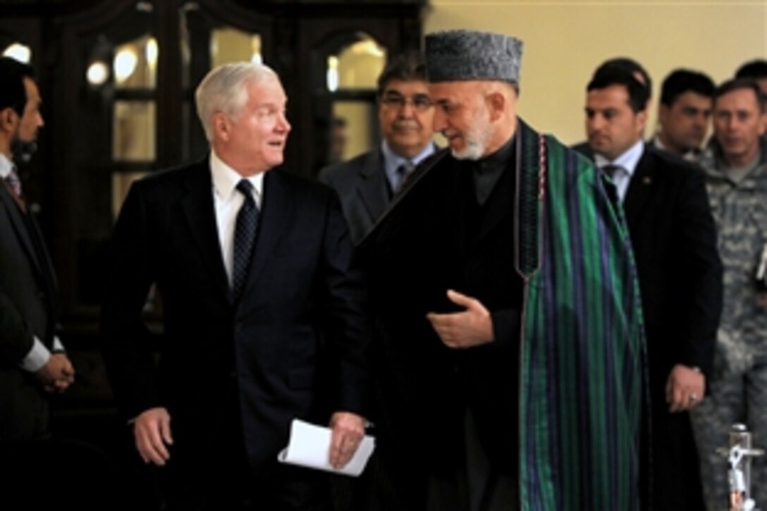 U.S. Defense Secretary Robert M. Gates and Afghanistan President Hamid Karzai walk to a press conference following their defense talks in Kabul, Afghanistan, March 7, 2011.  